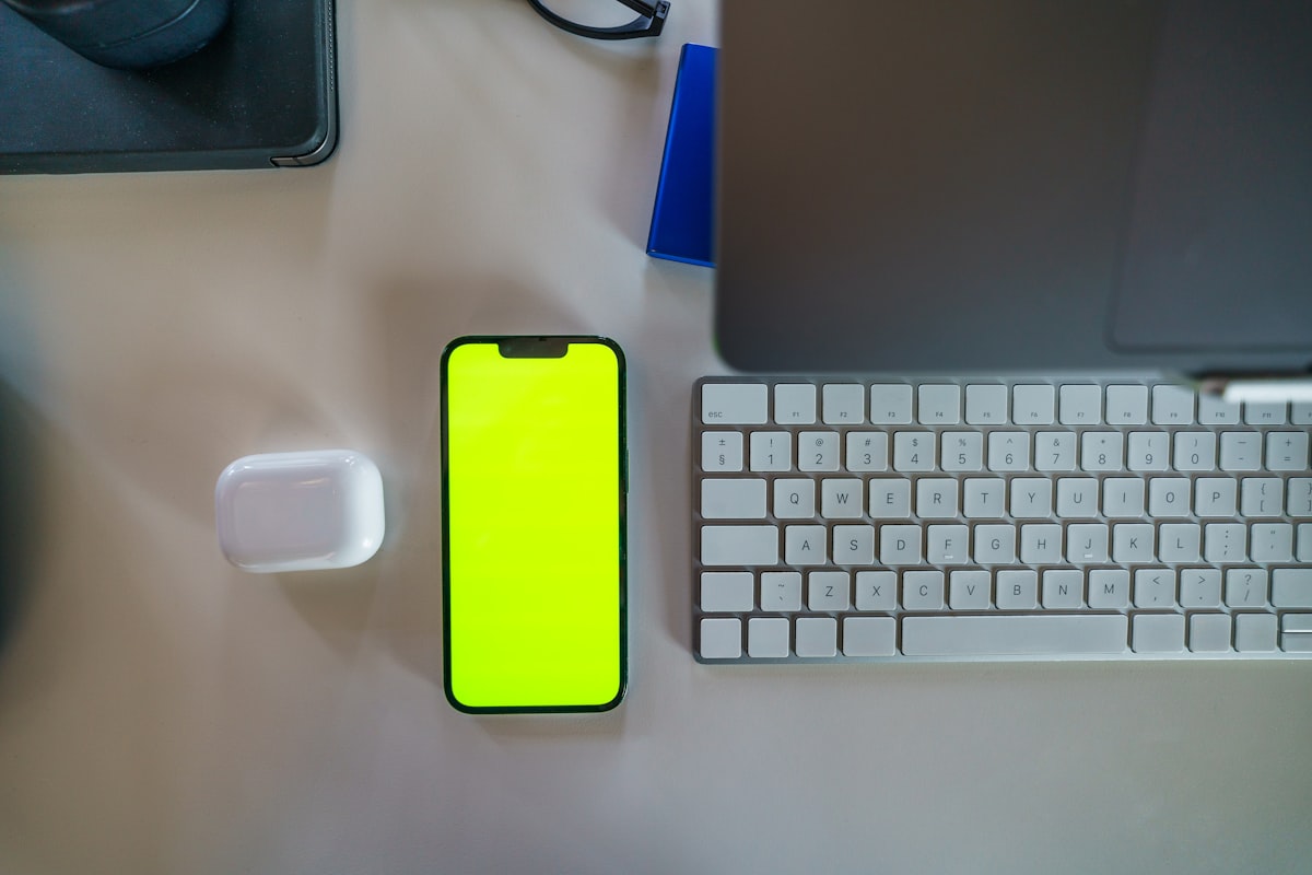 Smartphone on desk beside keyboard for mobile CV creation