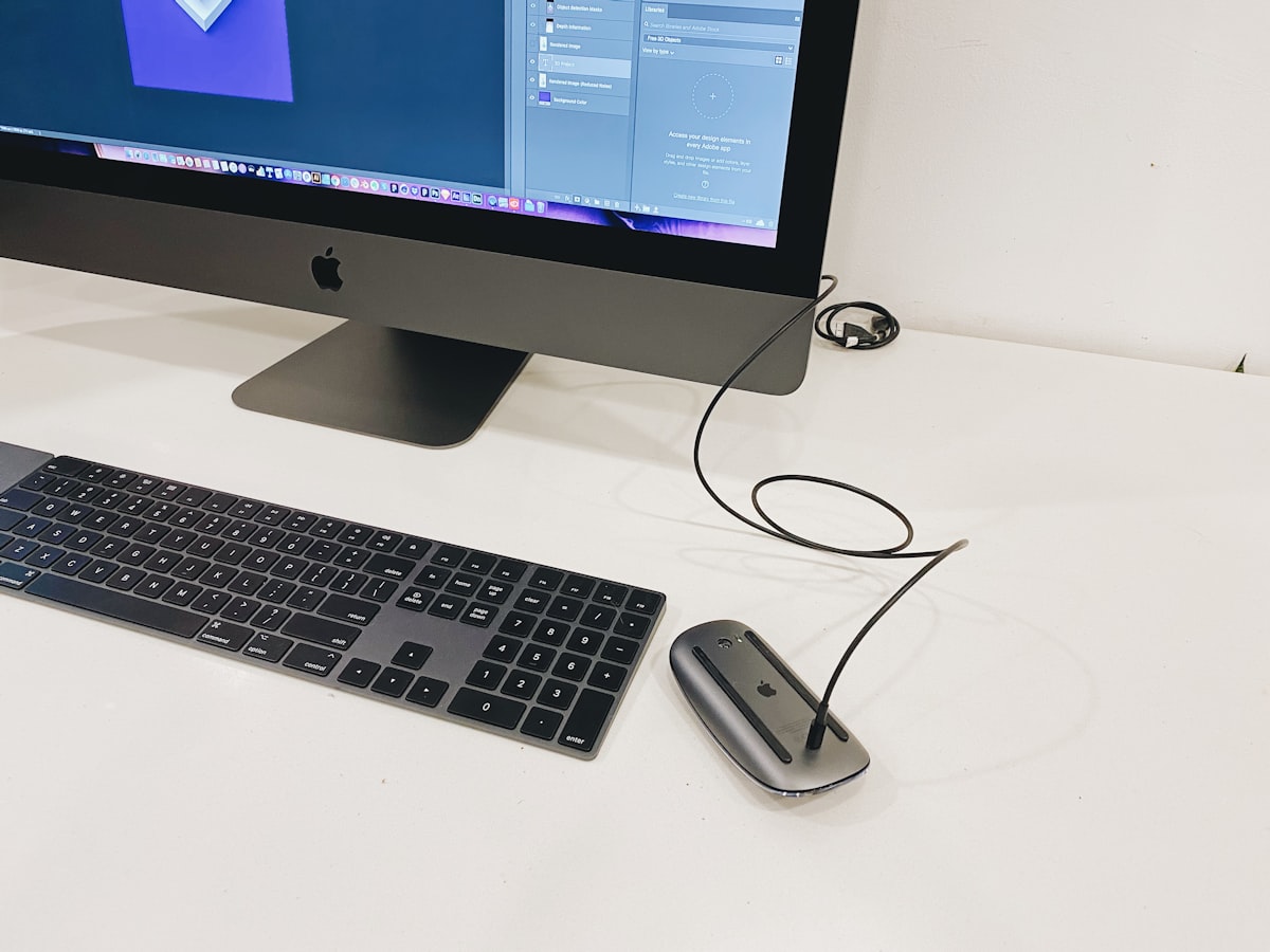 Modern computer setup with iMac keyboard and mouse