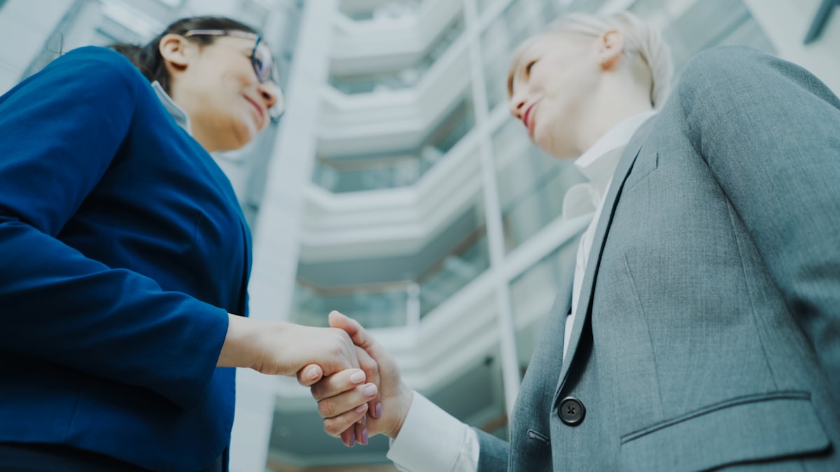 Two businesswomen shaking hands for new career opportunity
