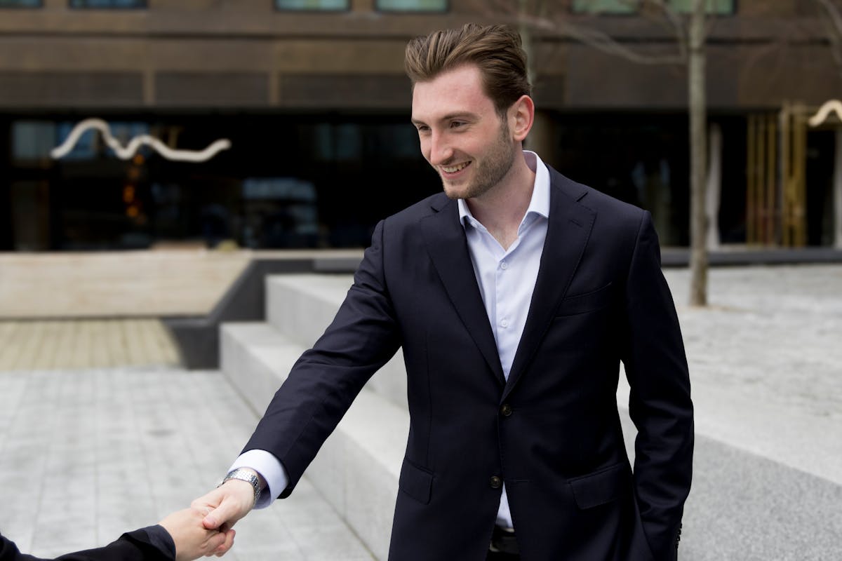 Smiling businessman in formal attire shaking hands
